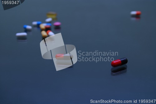 Image of pills on glosy surface