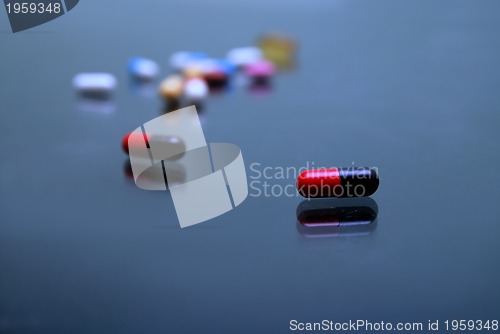 Image of pills on glosy surface