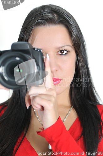 Image of Young woman holding camera in hand taking picture isolated