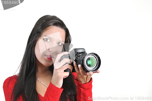 Image of Young woman holding camera in hand taking picture isolated