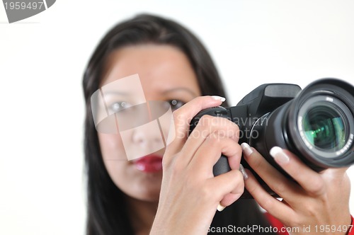 Image of Young woman holding camera in hand taking picture isolated