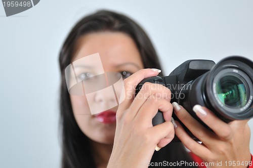 Image of Young woman holding camera in hand taking picture isolated