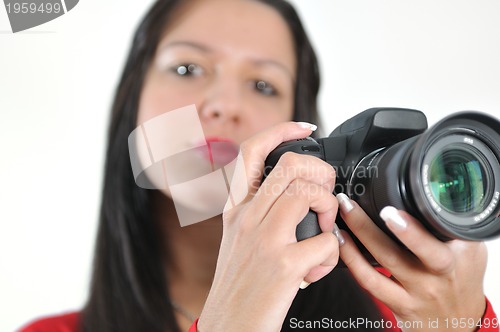 Image of Young woman holding camera in hand taking picture isolated