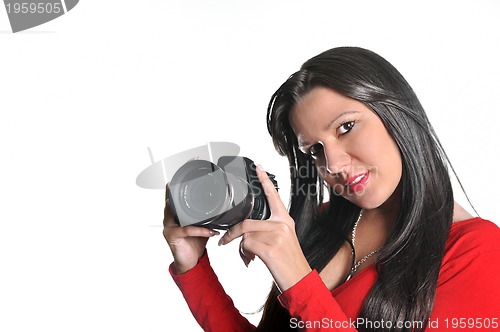 Image of Young woman holding camera in hand taking picture isolated