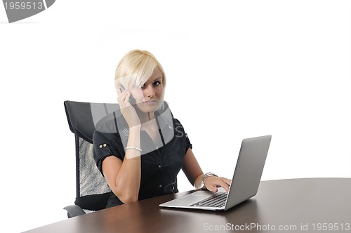 Image of  young business woman working in office on laptop