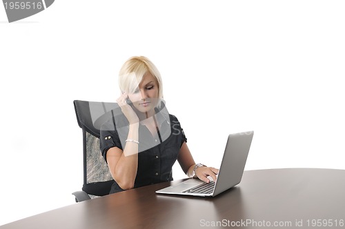 Image of  young business woman working in office on laptop