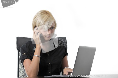 Image of  young business woman working in office on laptop