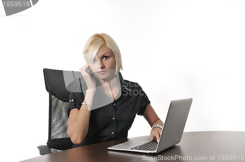 Image of  young business woman working in office on laptop