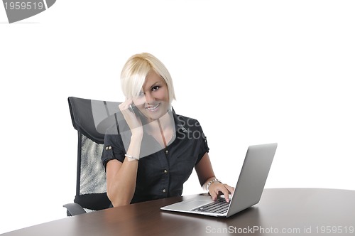 Image of  young business woman working in office on laptop