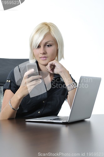 Image of  young business woman working in office on laptop