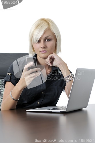 Image of  young business woman working in office on laptop