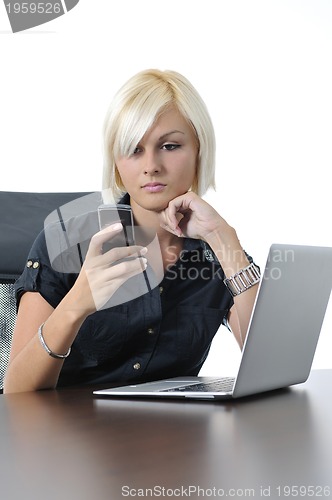 Image of  young business woman working in office on laptop