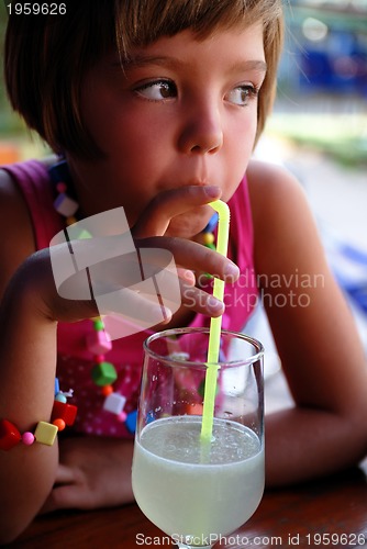 Image of Cute little gilr enjoying cold drink