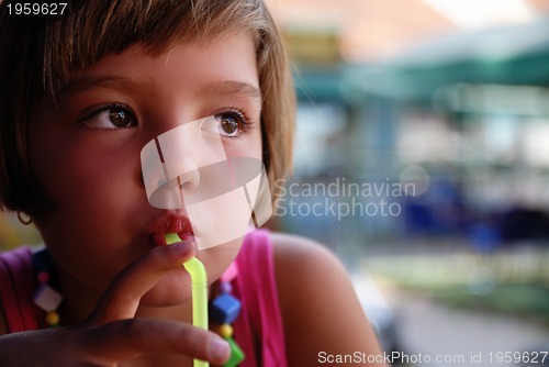 Image of Cute little gilr enjoying cold drink