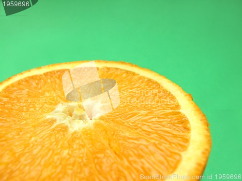 Image of sliced orange macro on green background