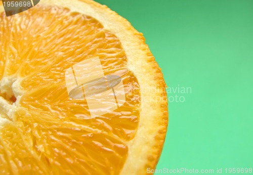 Image of sliced orange macro on green background