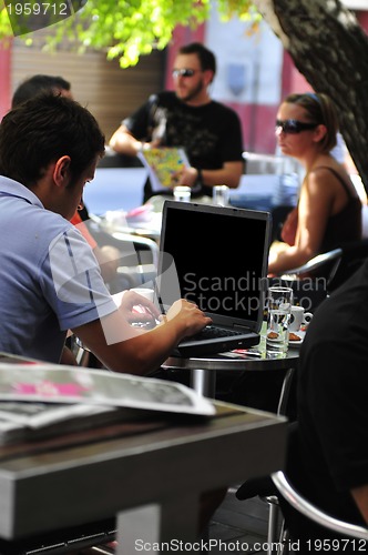 Image of picture of handsome businessman on leisure with laptop