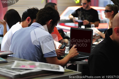 Image of picture of handsome businessman on leisure with laptop