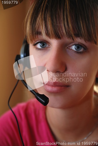 Image of Smart young woman using head-set