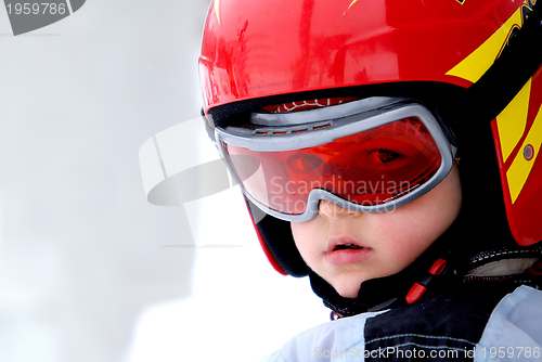 Image of Little skier with helmet and goggles