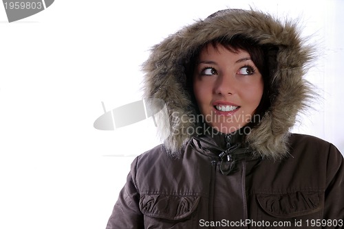 Image of Cute young woman smiling in winter jacket