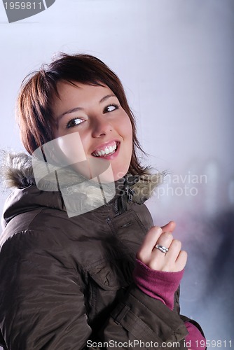 Image of Cute young woman smiling in winter jacket