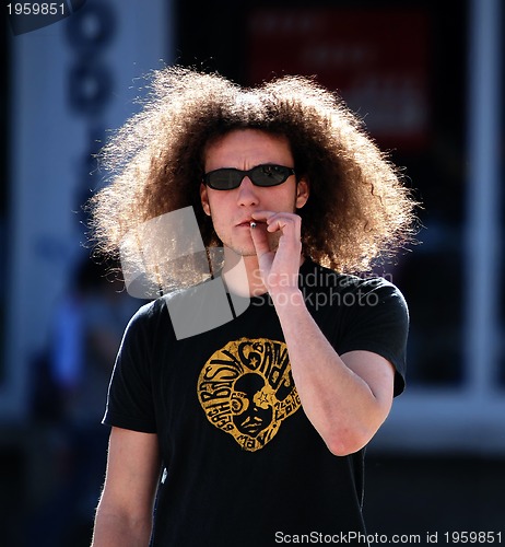 Image of Man smoking on the street