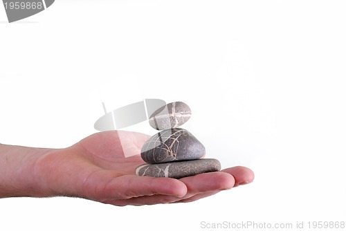 Image of Man holding balanced zen rocks