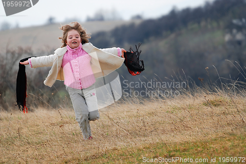 Image of beautiful running girl on meadow  with wind in their hair
