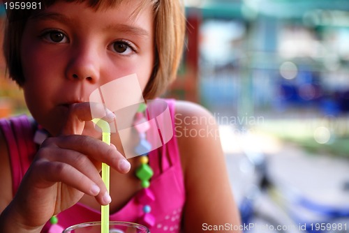 Image of Cute little gilr enjoying cold drink
