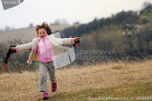Image of beautiful running girl on meadow  with wind in their hair