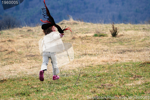 Image of beautiful running girl on meadow  with wind in their hair
