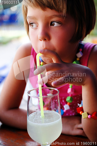 Image of Cute little gilr enjoying cold drink