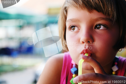 Image of Cute little gilr enjoying cold drink
