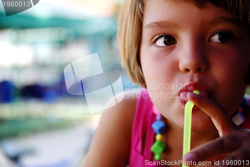 Image of Cute little gilr enjoying cold drink