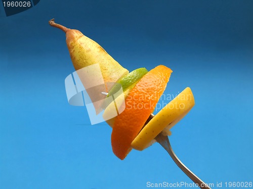 Image of sliced fruits on fork