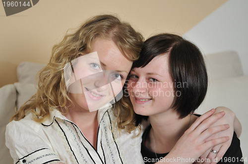 Image of young blonde and brunette  woman portrait