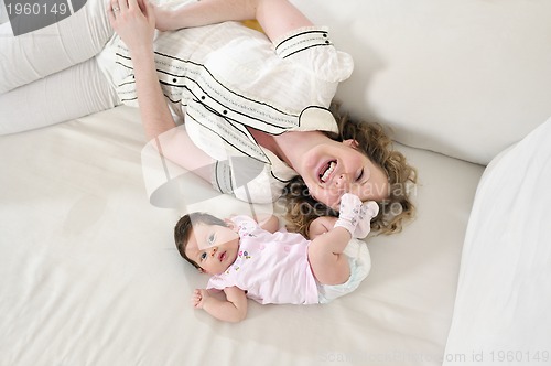 Image of beautiful young mother small with little baby