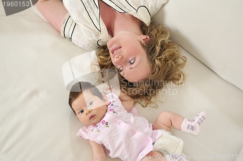 Image of beautiful young mother small with little baby