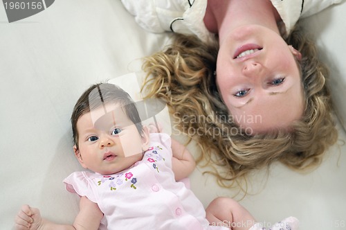 Image of beautiful young mother small with little baby