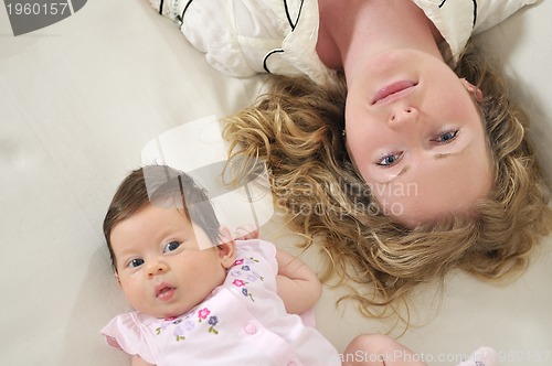 Image of beautiful young mother small with little baby