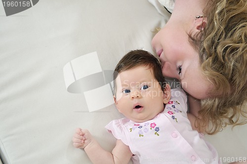 Image of beautiful young mother small with little baby