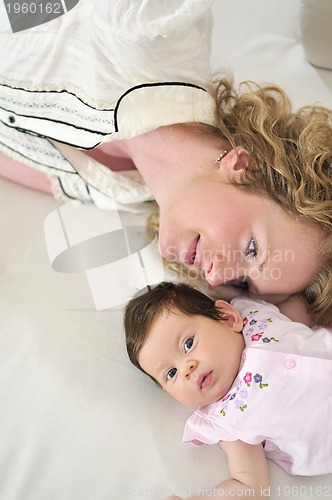 Image of beautiful young mother small with little baby