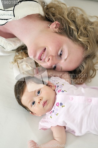 Image of beautiful young mother small with little baby