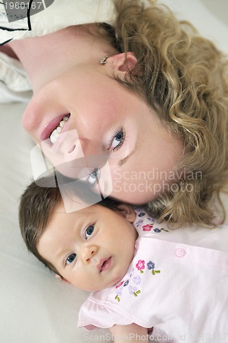 Image of beautiful blonde young mother and cute baby
