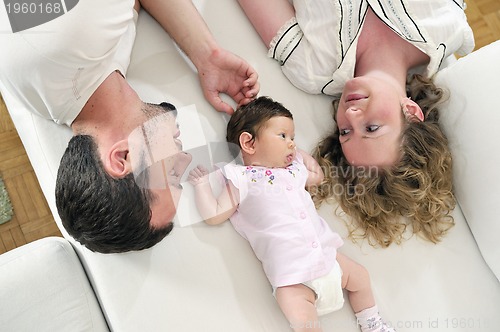 Image of indoor portrait with happy young family and  cute little babby 