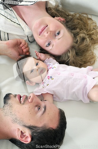 Image of indoor portrait with happy young family and  cute little babby 