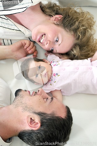 Image of indoor portrait with happy young family and  cute little babbybe