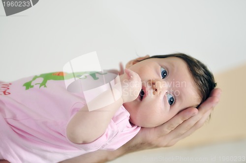 Image of indoor portrait with happy young famil and  cute little babby 