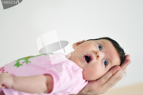 Image of indoor portrait with happy young famil and  cute little babby 